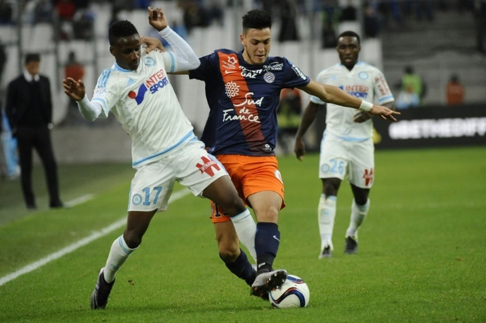 Marseilles Guinean midfielder Bouna Sarr (L) is tackled by Montpellierâs Algerian defender Ramy Bensebaini during the French Ligue 1 match on December 6, 2015 at the Velodrome Stadium in Marseille