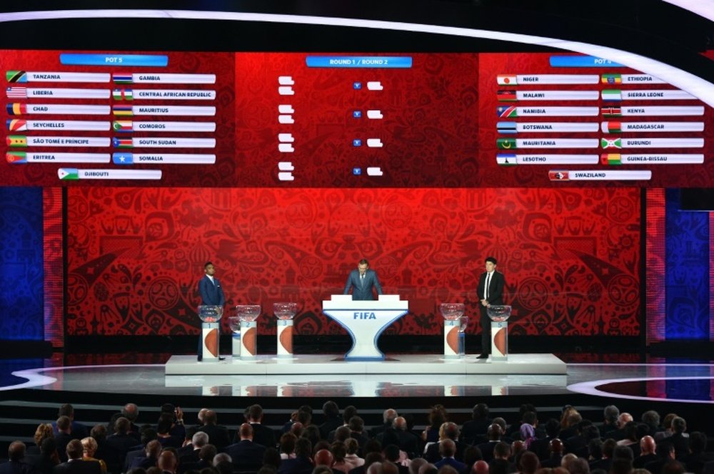 (L-R) Samuel Etoo, Jerome Valcke and Rinat Dasaev hold the preliminary draw for the Confederation of African Football (CAF) zone for the 2018 World Cup qualifiers at the Konstantin Palace in Saint Petersburg on July 25, 2015