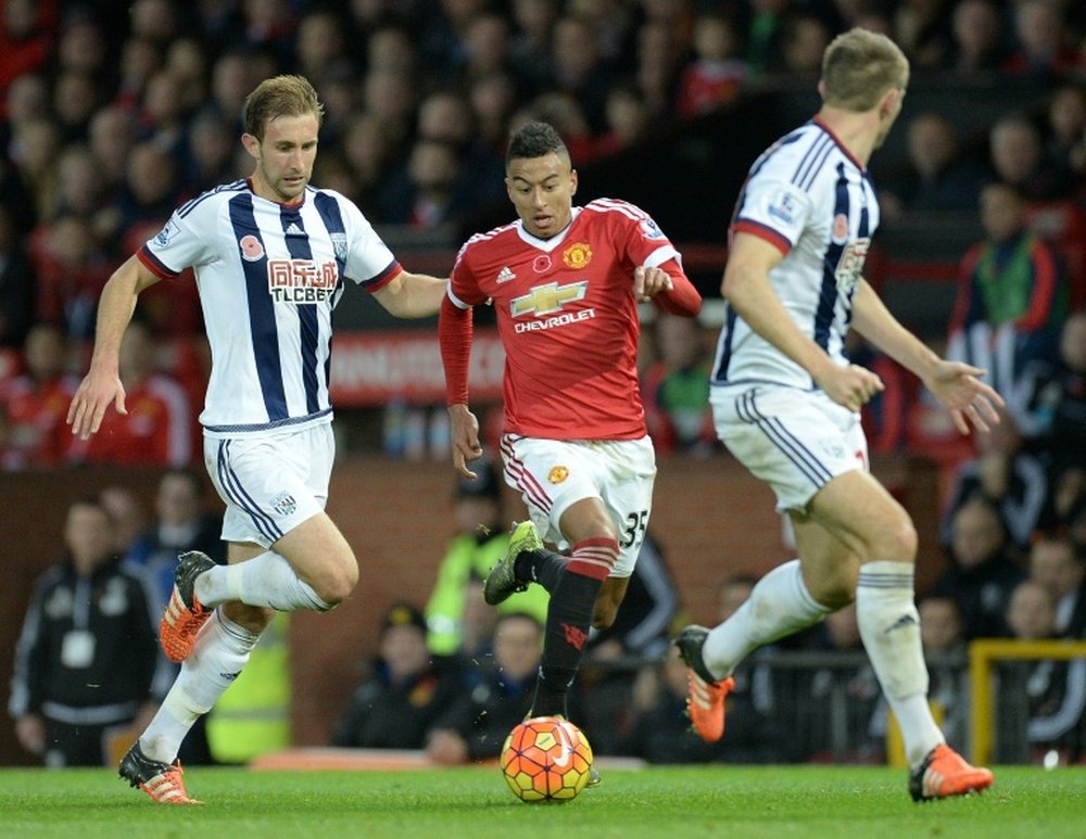 Man Uniteds midfielder Jesse Lingard (C) vies against West Bromwich Albions defender Craig Dawson (L) and defender Gareth McAuley during the English Premier League football match in Manchester, England, on November 7, 2015