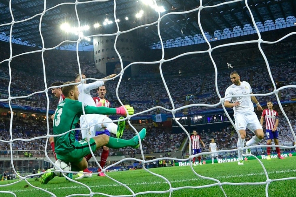 Real Madrids Sergio Ramos scores the opening goal during the UEFA Champions League final between Real and Atletico Madrid at San Siro Stadium in Milan, on May 28, 2016