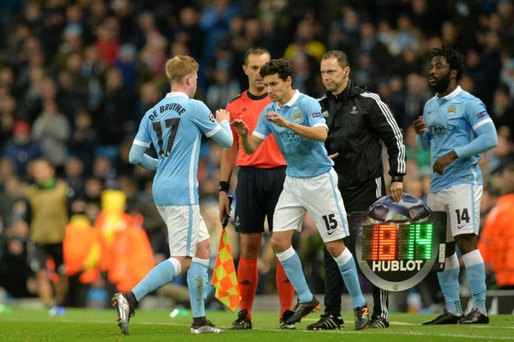Manchester Citys Kevin De Bruyne (L) is substituted for midfielder Jesus Navas (C) during the UEFA Champions League Group D football match at the Etihad Stadium in Manchester, England, on December 8, 2015