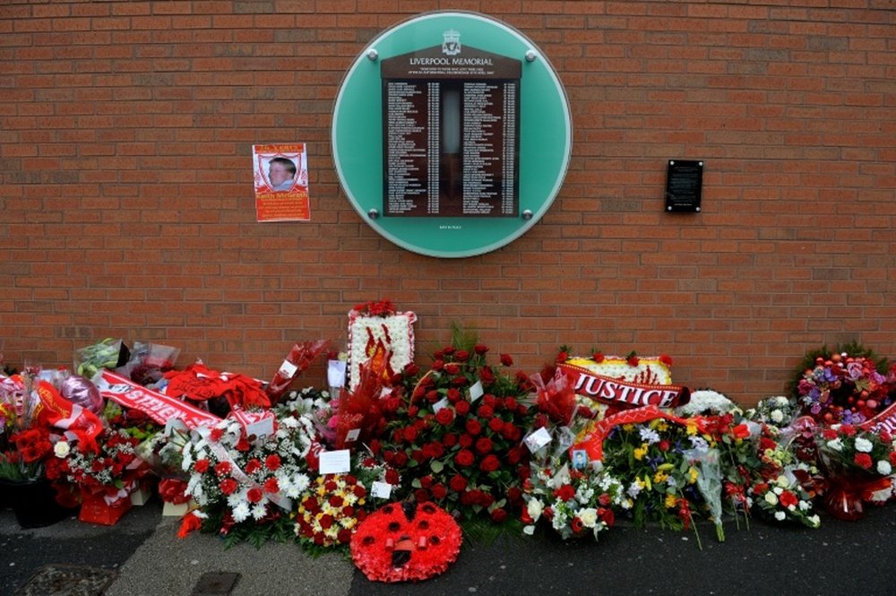 Flowers sit beneath a Hillsborough disaster memorial at Anfield in Liverpool, Engand