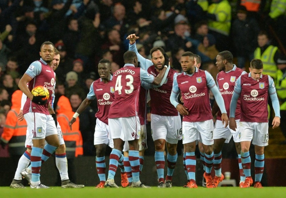 Aston Villa players celebrate during an English Premier League football match at Villa Park in Birmingham, central England on January 12, 2016