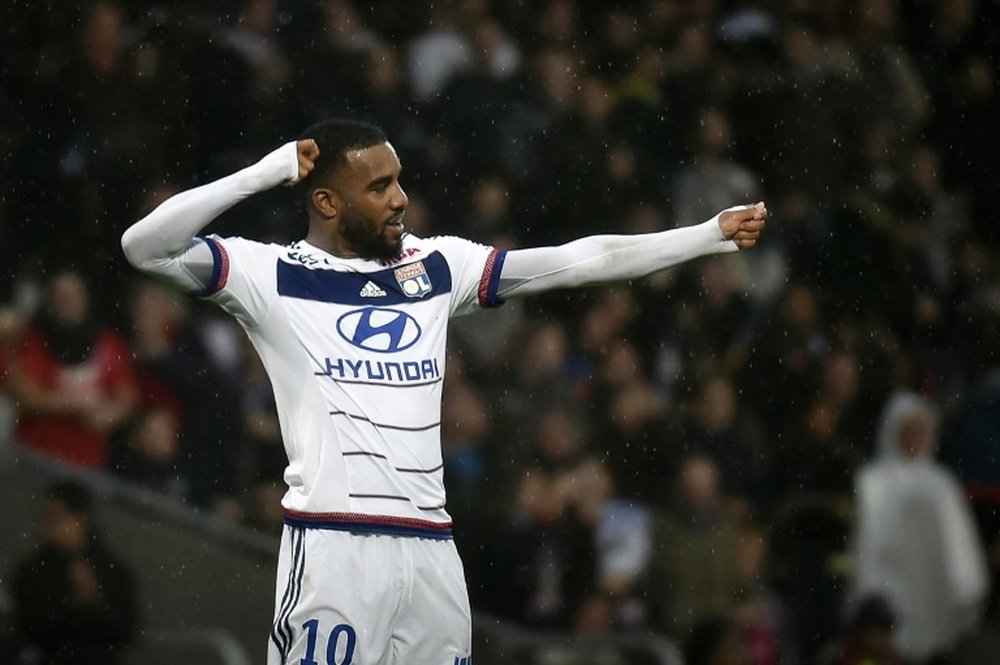 Lyons forward Alexandre Lacazette celebrates after scoring a goal during a French L1 football match against Reims on October 3, 2015, at the Gerland Stadium in Lyon