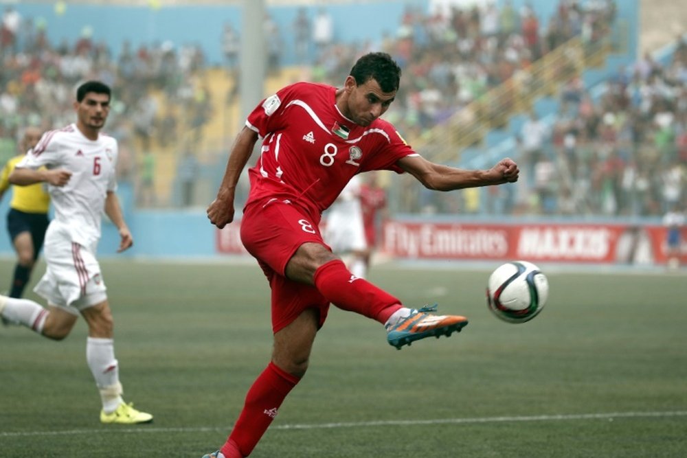 Palestinian forward Sameh Maraaba (C) kicks the ball during his 2018 FIFA World Cup qualifying football match against UAE at the Faisal al-Husseini Stadium, on September 8, 2015, in the West Bank town of Al-Ram