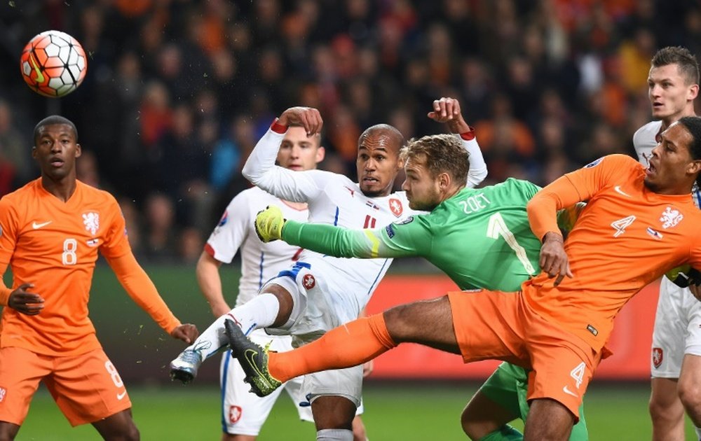 Netherlands goalkeeper Jeroen Zoet attempts to stop a ball kicked by Czechs Theodor Gebre Selassie (CL) during the Euro 2016 qualifying football match at the Amsterdam Arena in Amsterdam, October 13, 2015