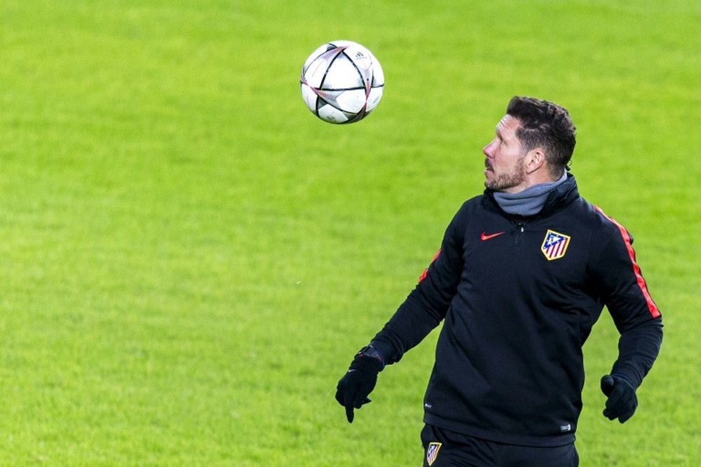 Atletico Madrids coach Diego Simeone controls a ball during a training session in Eindhoven on February 23, 2016