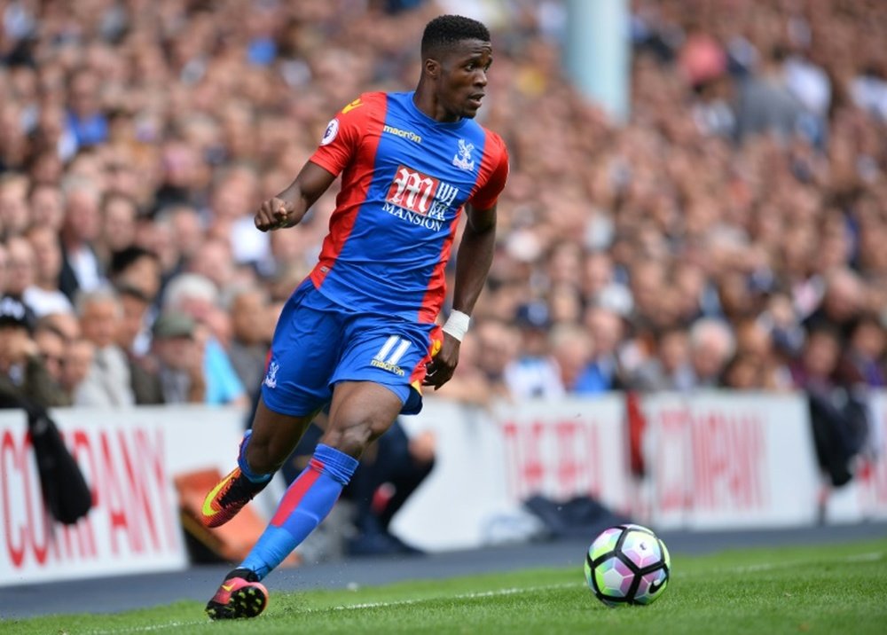 Crystal Palaces Ivorian-born English striker Wilfried Zaha runs with the ball during the English Premier League match against Tottenham Hotspur at White Hart Lane in London, on August 20, 2016