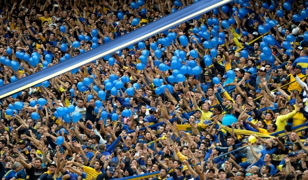 Supporters of Boca Juniors cheer their team before the Argentina First Divison football match against River Plate at La Bombonera stadium in Buenos Aires, Argentina, on April 24, 2016