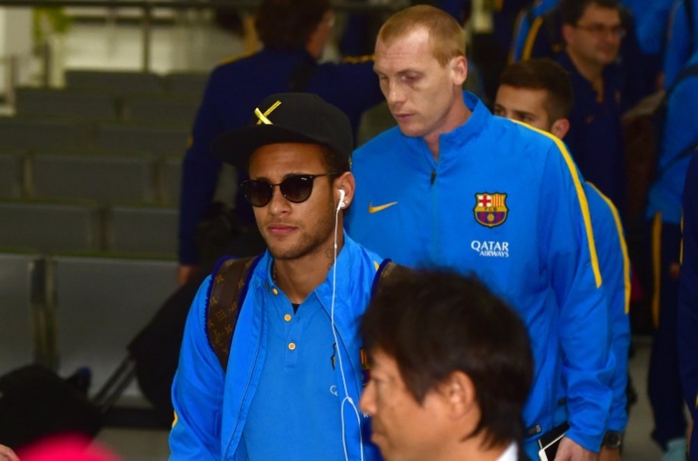 Barcelona forward Neymar (left) arrives in Tokyo for the Club World Cup, on December 14, 2015