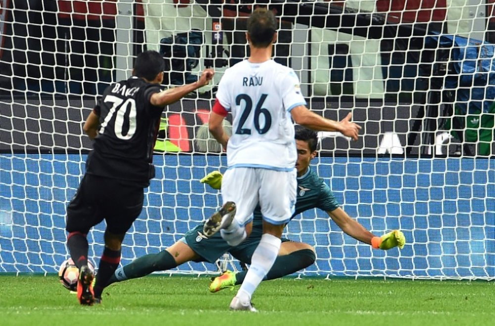 AC Milans Colombian forward Carlos Bacca (L) kicks and scores a goal during the Italian Serie A football match between AC Milan and SS Lazio at the San Siro Stadium in Milan, on September 20, 2016