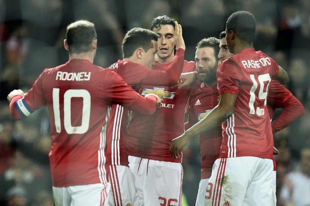 Juan Mata and team-mates celebrating a goal in their last match against Hull City. AFP