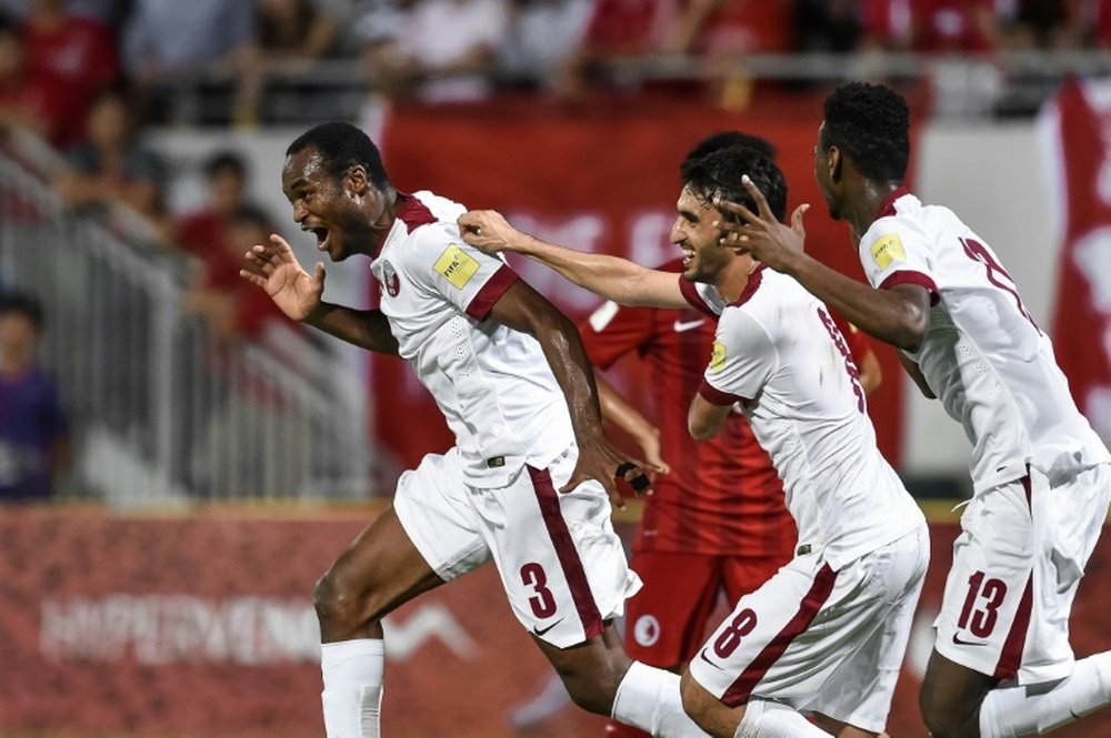 Qatars Abdelkarim Hassan (L) celebrates after scoring a goal during the 2018 World Cup football qualifying match between Qatar and Hong Kong in Hong Kong on September 8, 2015