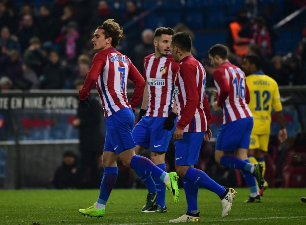 Atletico Madrids forward Antoine Griezmann (L) celebrates after scoring during the Spanish Copa del Rey round of 16 second leg football match against Las Palmas January 10, 2017