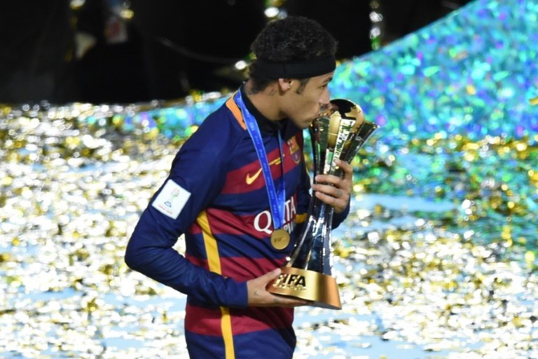 Barcelonas Neymar celebrates with the Club World Cup trophy after the 3-0 victory over River Plate in Yokohama, on December 20, 2015