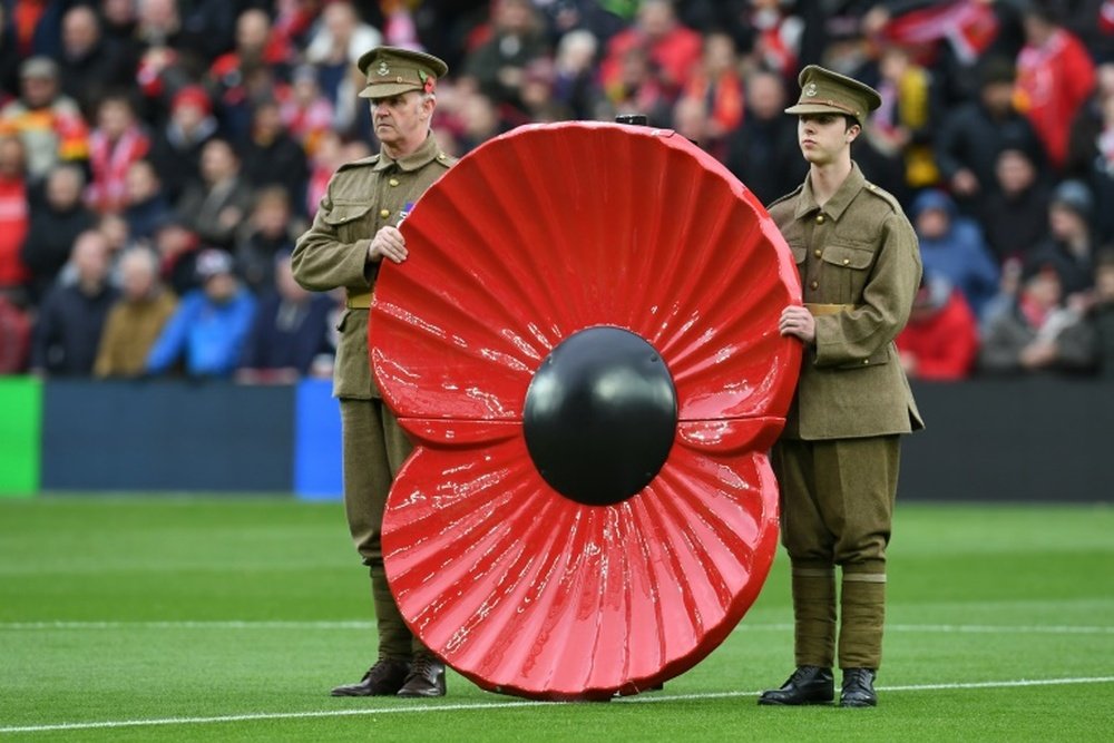 A giant poppy is displayed during a minutes silence in honour of Remembrance Day during the English Premier League football match between Liverpool and Watford at Anfield in Liverpool, north west England on November 6, 2016