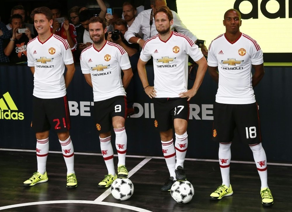 (From L) Manchester Uniteds Ander Herrera, Juan Mata, Daley Blind and Ashley Young pose in the new Adidas away kit at a launch event in London, on August 11, 2015