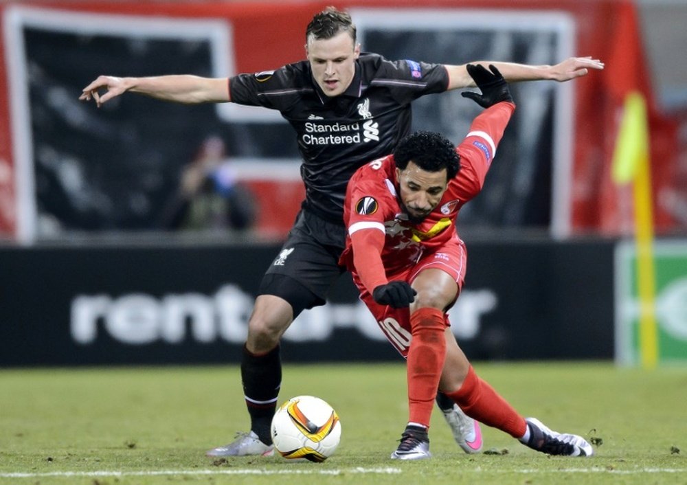 Liverpools defender Brad Smith (L) and Sions midfielder Carlitos fight for the ball during a UEFA Europa League match at the Tourbillon stadium in Sion on December 10, 2015