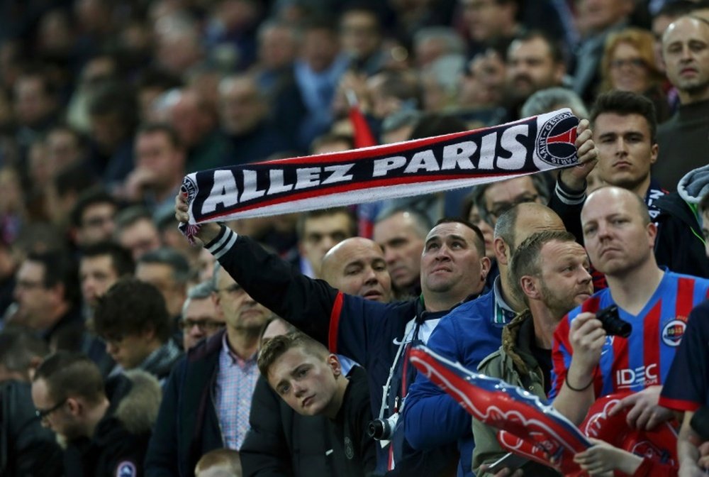 A Paris Saint-Germain fan is pictured before the French L1 football match between Caen and Paris Saint-Germain, on December 19, 2015 in Caen, northwestern France