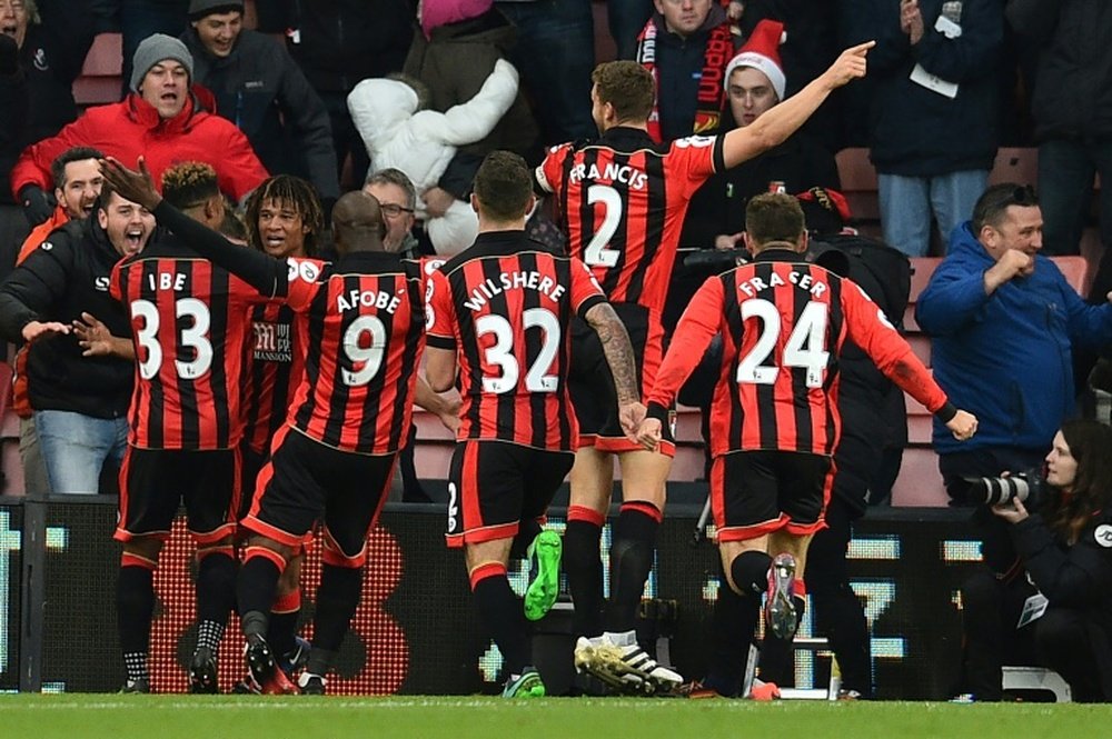 Bournemouth players celebrate their fourth goal against Liverpool. AFP
