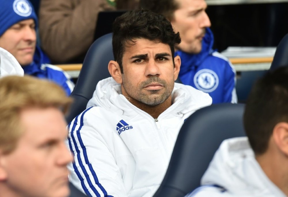 Chelsea striker Diego Costa sits on the bench before the Premier League match against Tottenham Hotspur at White Hart Lane in north London on November 29, 2015