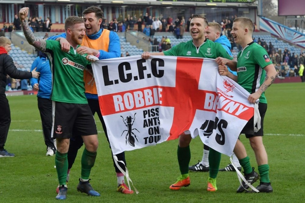 Lincoln City celebrate their FA Cup 5th-round victory against Burnley on Saturday. AFP