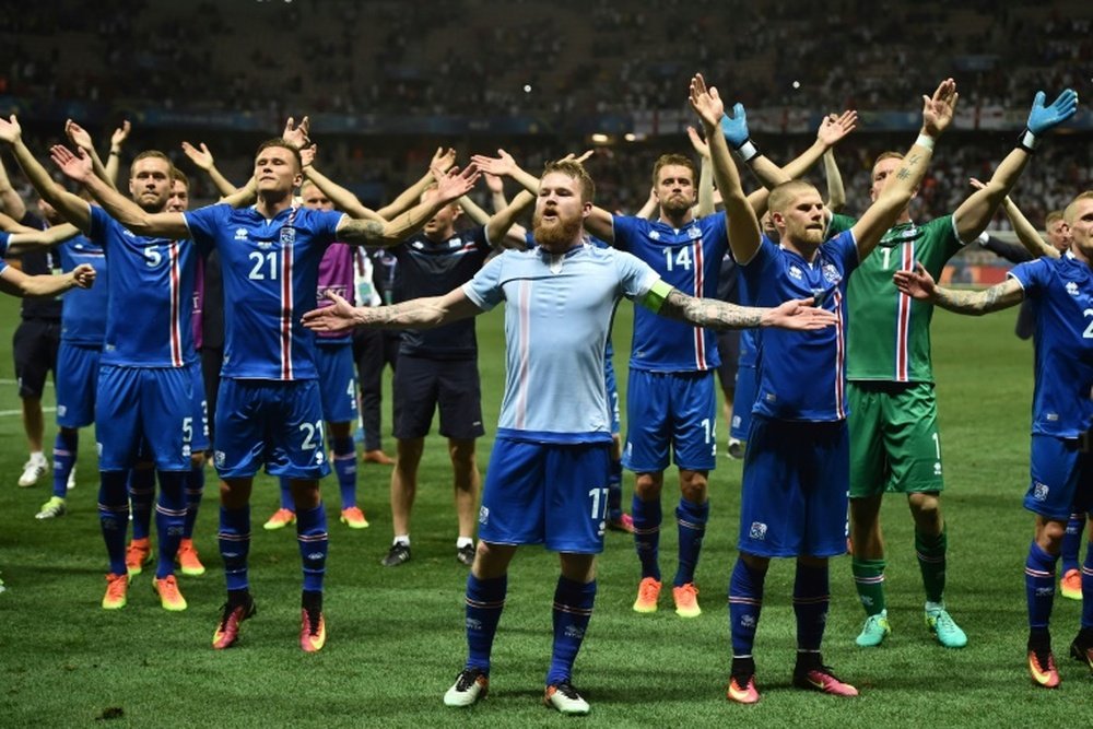 Icelands midfielder Aron Gunnarsson (C) and other players celebrate their teams win after the Euro 2016 round of 16 football match between England and Iceland at the Allianz Riviera stadium in Nice on June 27, 2016