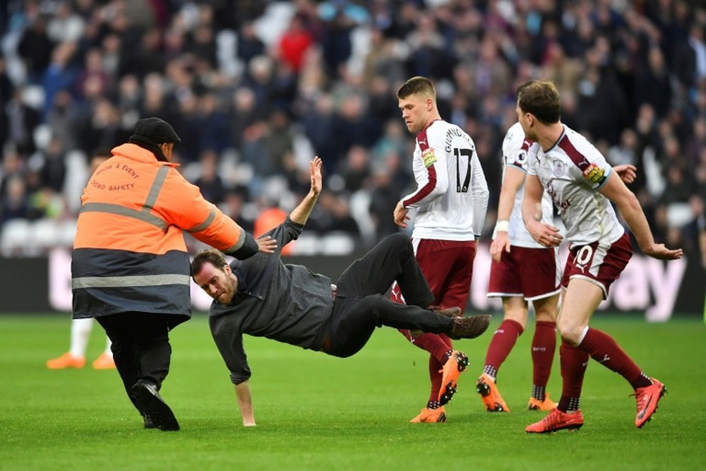 Fans took to the pitch to show their frustration with results. AFP