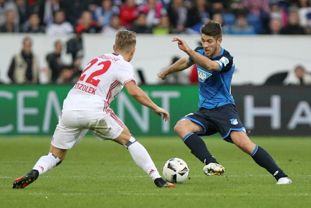 Hoffenheim's Sandro Wagner and Hamburg's Matthias Ostrzolek (L) fight for the ball. AFP