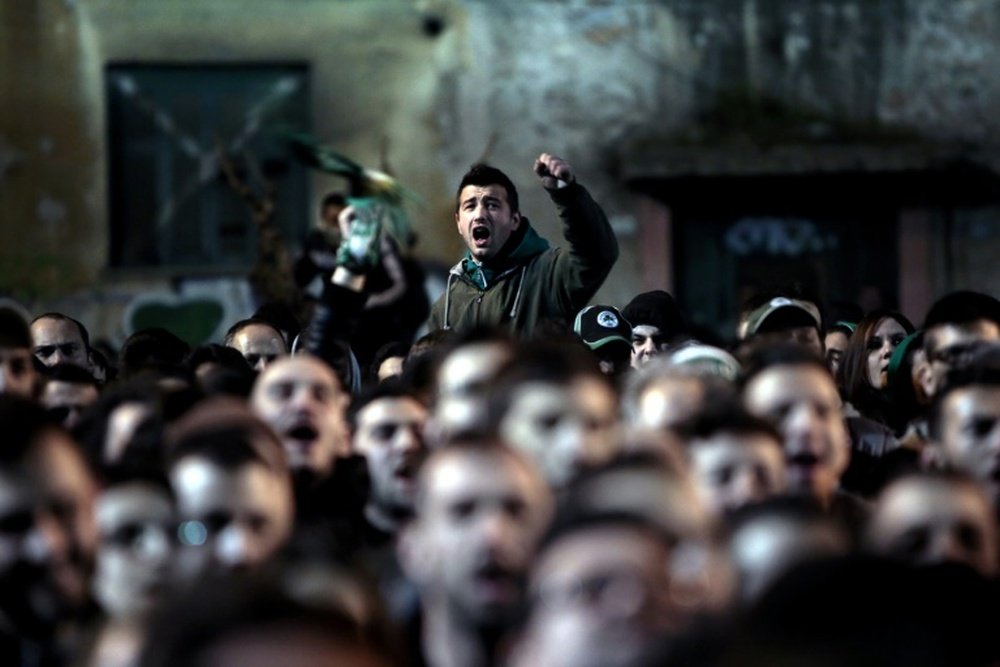 Panathinaikos supporters watch a football match on March 8, 2015 on a screen in the streets of Athens