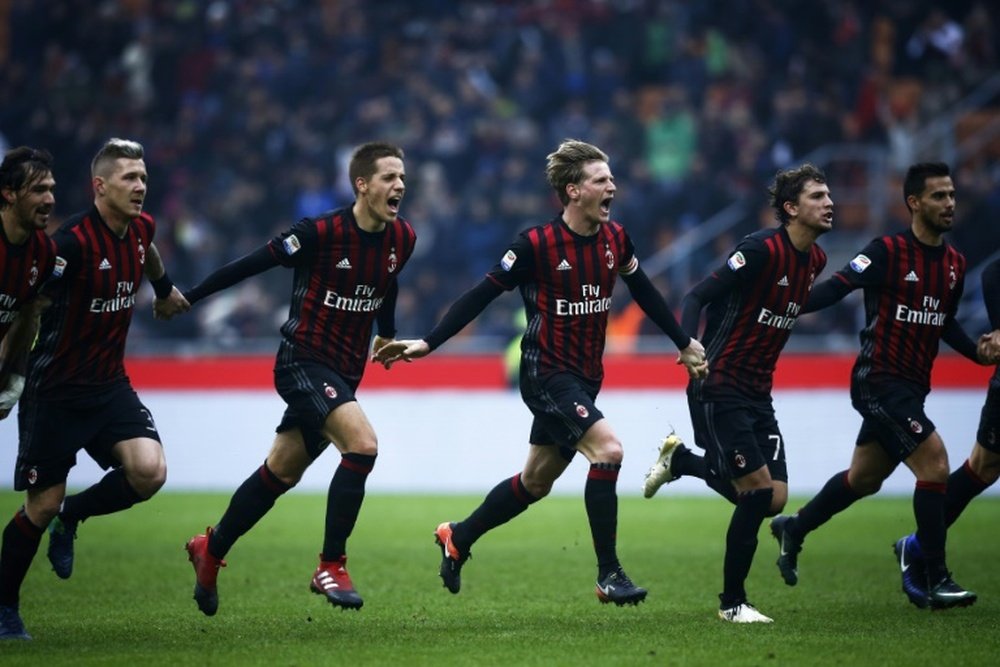 AC Milans players celebrate after winning the Italian Serie A match against Crotone on December 4, 2016 at the San Siro Stadium in Milan