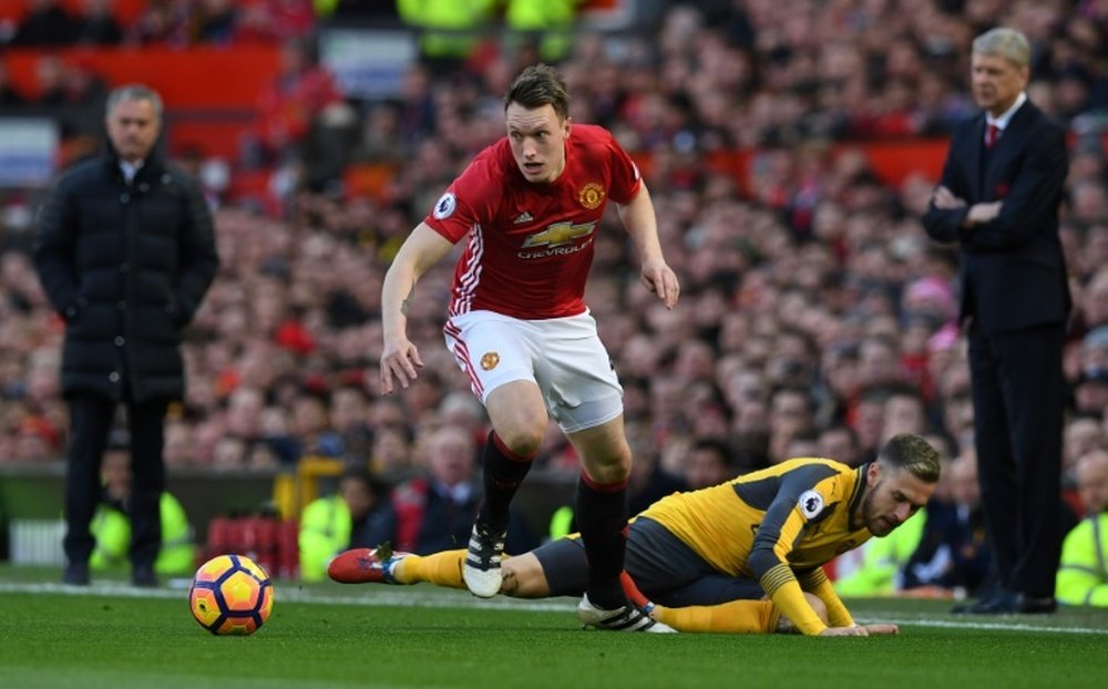 Phil Jones is banned for Tuesday's Champions League clash. AFP