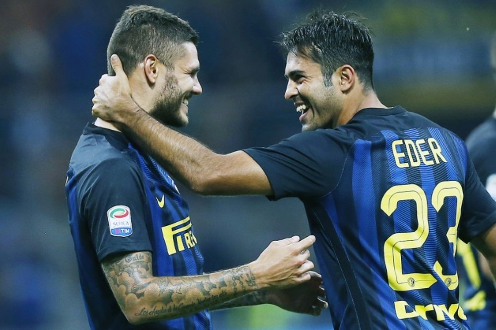 Inter Milans forward Mauro Emanuel Icardi from Argentina celebrates with Inter Milans forward Citadin Martins Eder during the Italian Serie A football match Inter Milan vs Juventus on September 18, 2016