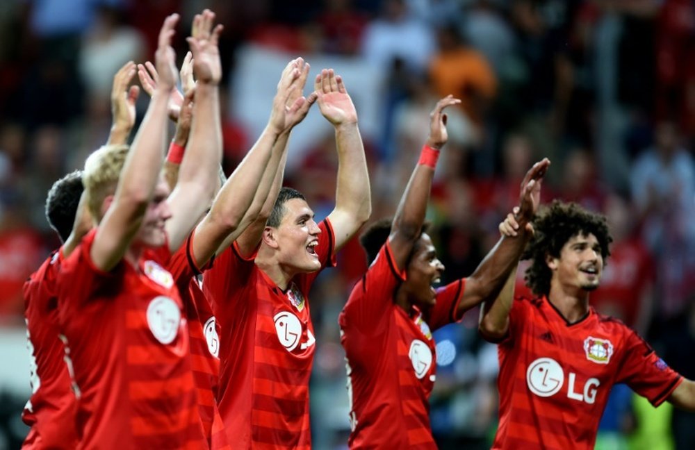 Leverkusens players celebrate after the UEFA Champions League second leg playoff football match between Bayer Leverkusen and SS Lazio in Leverkusen, western Germany, on August 26, 2015