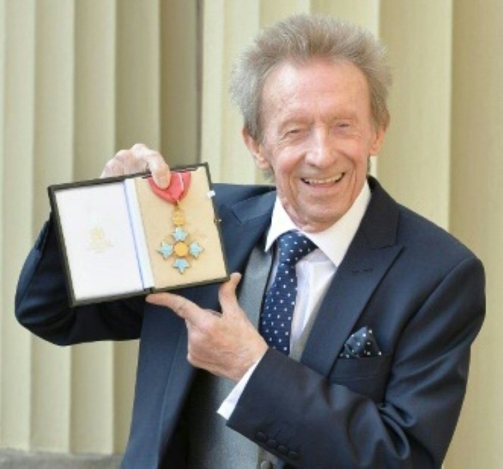 Former Scotland and Manchester United football player Denis Law holds his Commander of the Order of the British Empire (CBE) medal after an investiture ceremony in Buckingham Palace, London on March 11, 2016