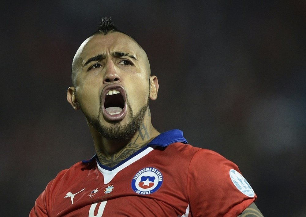 Chiles midfielder Arturo Vidal celebrates after scoring against Argentina during the penalty shootout of the 2015 Copa America football championship final, in Santiago, Chile, on July 4, 2015. AFP PHOTO / JUAN MABROMATA