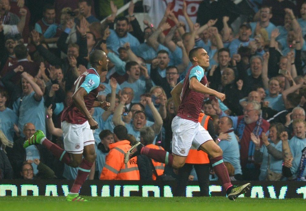 West Ham Uniteds defender Winston Reid (R) celebrates after scoring the winning goal during the English Premier League football match between West Ham United and Manchester United in Upton Park, in east London on May 10, 2016