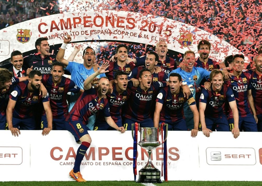 Barcelona players pose as they celebrate their victory over Athletic Bilbao at the end of the Spanish Copa del Rey final football match at the Camp Nou stadium in Barcelona on May 30, 2015
