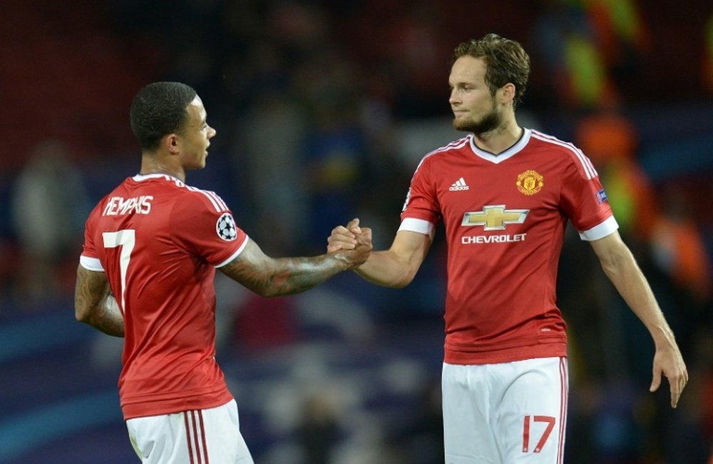 Manchester Uniteds Memphis Depay (L) and teammate Daley Blind celebrate after defeating Club Brugge 3-1 during the Champions League play off match at Old Trafford on August 18, 2015