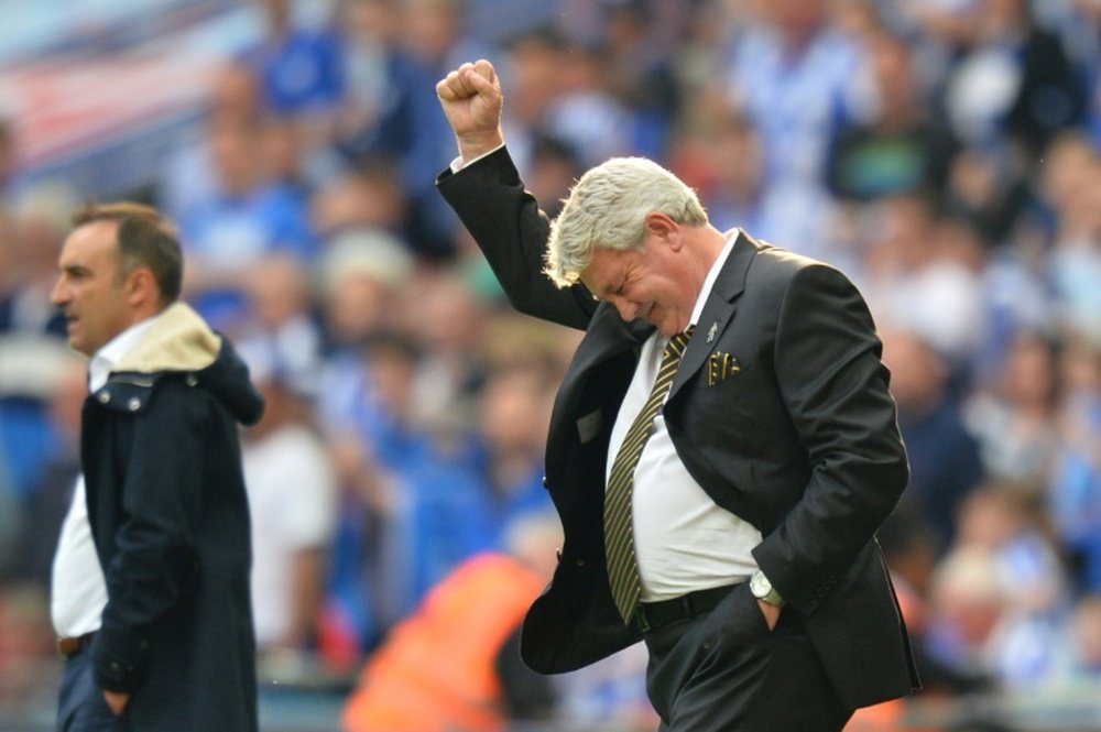Steve Bruce holding up his hand. AFP