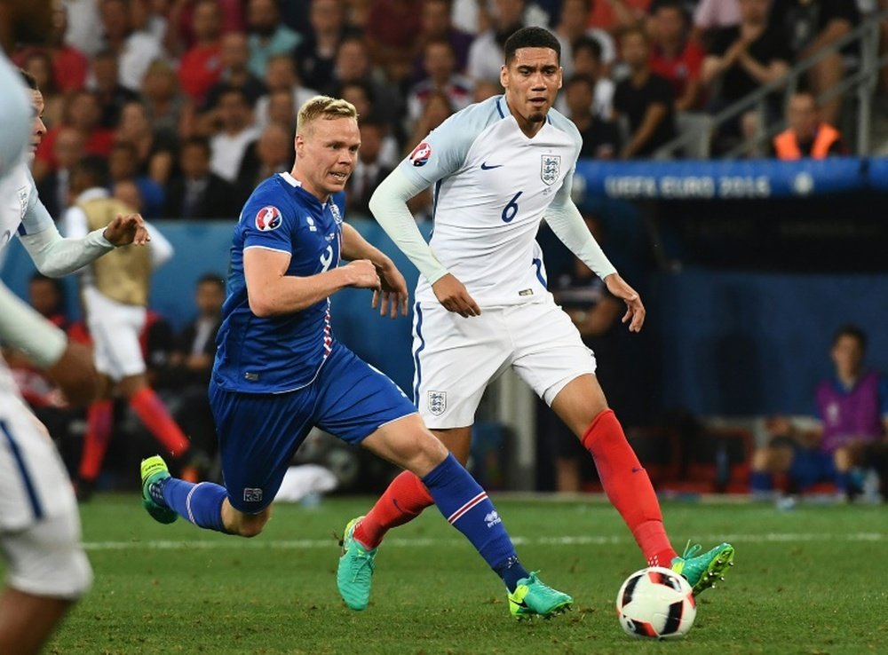 Englands defender Chris Smalling (R) and Icelands forward Kolbeinn Sigthorsson vie for the ball during Euro 2016 round of 16 football match between England and Iceland at the Allianz Riviera stadium in Nice on June 27, 2016