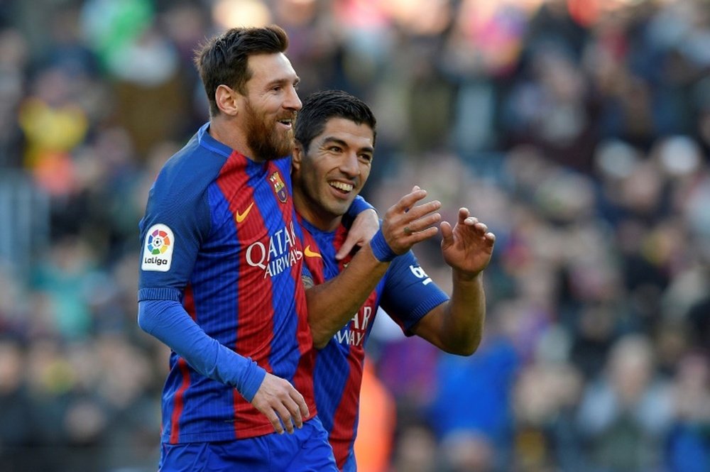 Barcelona's Luis Suarez celebrates with team-mate Lionel Messi after scoring. AFP