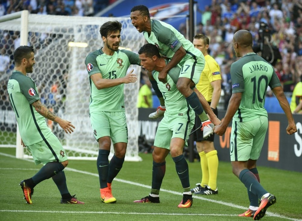 Portugals forward Cristiano Ronaldo (3L) celebrates with teammates after scoring his teams second goal during the Euro 2016 match between Hungary and Portugal, on June 22, 2016