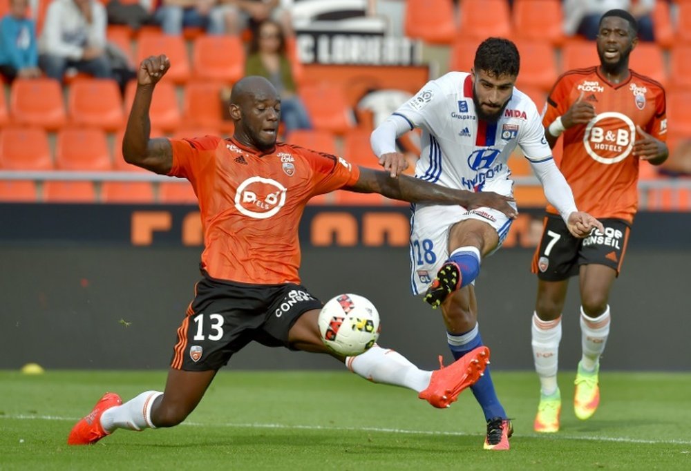 Lyon's Nabil Fekir (C) vies with Lorient defender Michael Ciani. AFP
