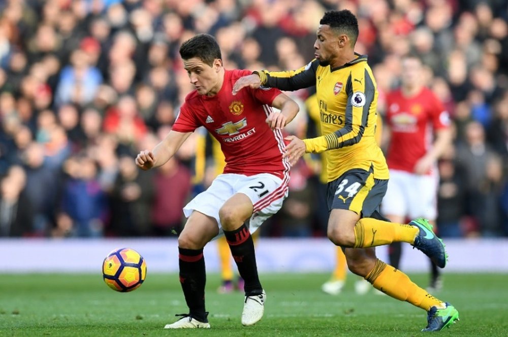 Manchester United's Ander Herrera (left) vies with Arsenal's Francis Coquelin. AFP