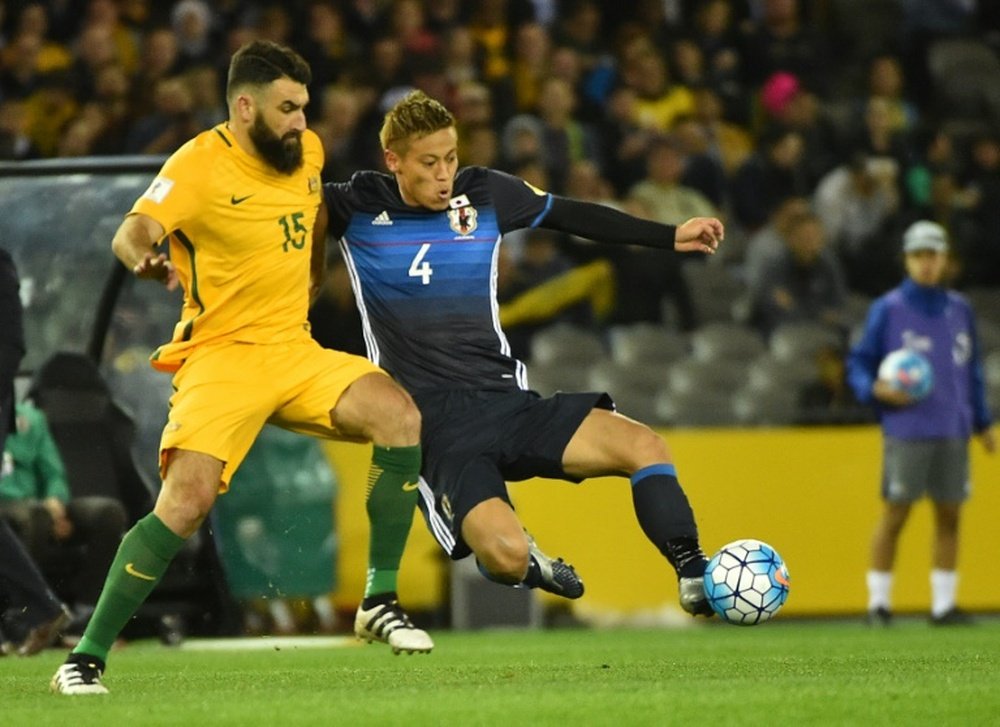 Japans Keisuke Honda (right) battles for the ball with Australias Mile Jedinak during a World Cup qualifier in Melbourne on October 11, 2016