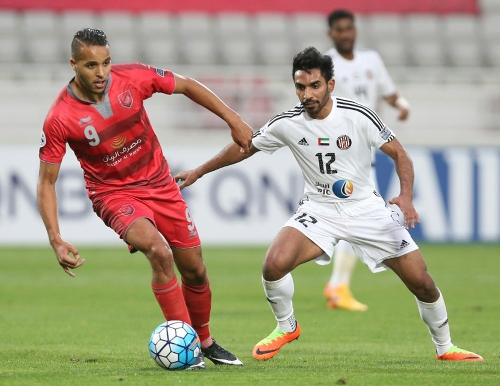 UAEs Al-Jazira player Salim Rashid (R) fights for the ball. AFP
