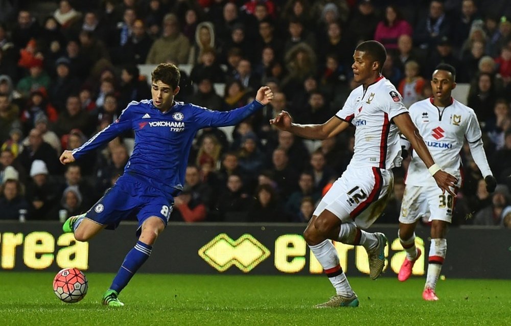 Chelseas midfielder Oscar (L) shoots to score his third goal during the English FA Cup fourth round football match between MK Dons and Chelsea at Stadium MK in Milton Keynes, England, on January 31, 2016