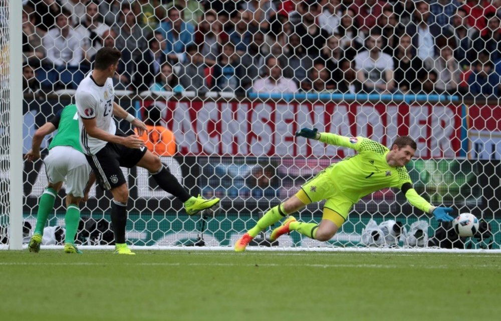 Northern Irelands goalkeeper Michael McGovern stops a goal attempt by Germanys forward Mario Gomez during the Euro 2016 group C football match between Northern Ireland and Germany at the Parc des Princes stadium in Paris on June 21, 2016.