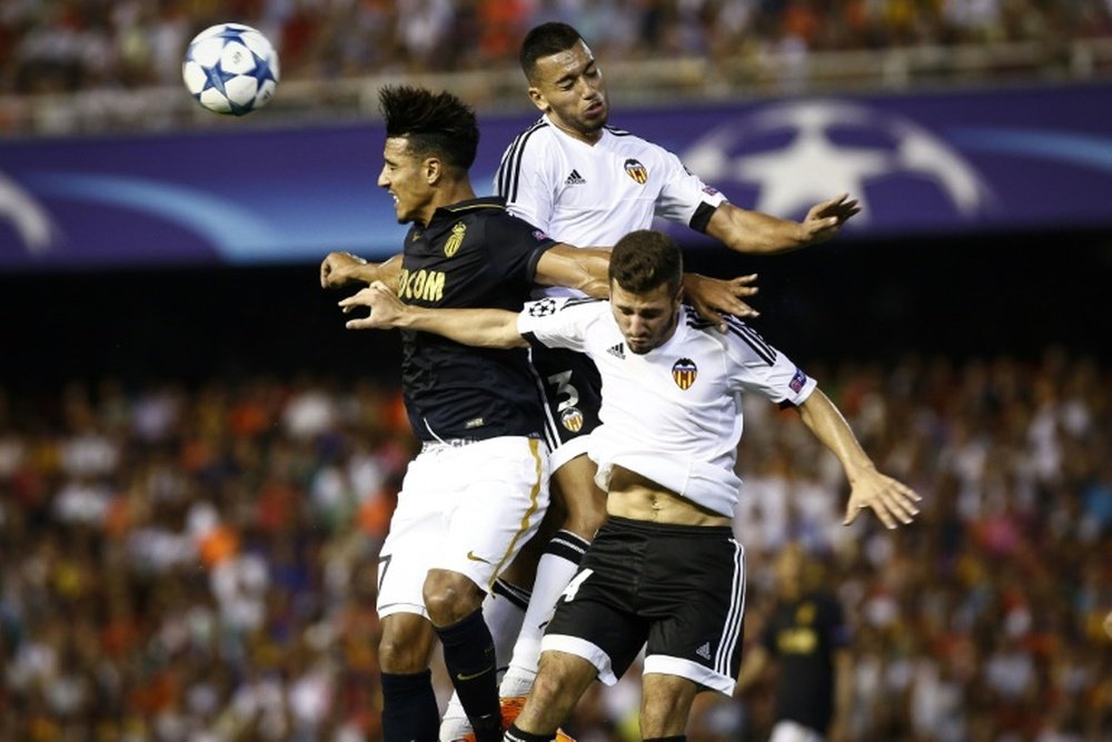 Monaco's Moroccan midfielder Nabil Dirar (R) vies with Valencia's Portuguese defender Ruben Vezo (C) and Spanish defender Jose Gaya during the UEFA Champions League playoff football match in Valencia on August 19, 2014
